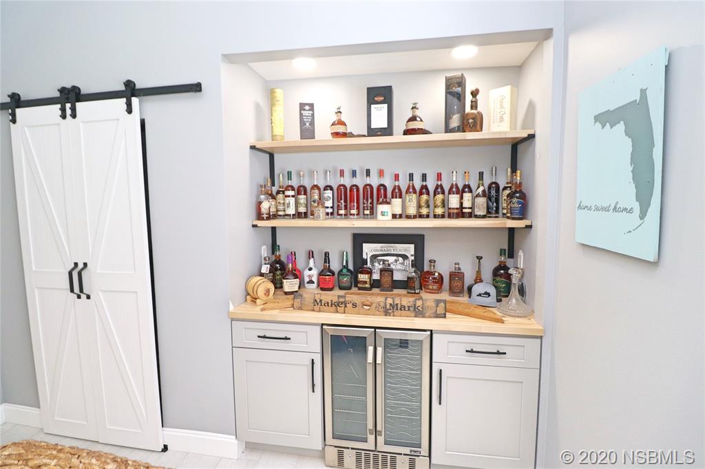 129 Rhode Island Street Edgewater, FL 32132 - Photo 10 of 49 a kitchen with a refrigerator and cabinets
