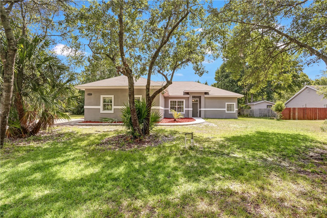 96921 Blackrock Road Yulee, FL 32097 - Photo 1 of 34 a front view of a house with a garden