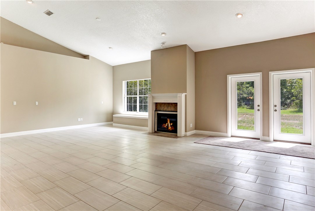 96921 Blackrock Road Yulee, FL 32097 - Photo 12 of 34 a view of an empty room with a fireplace and a window
