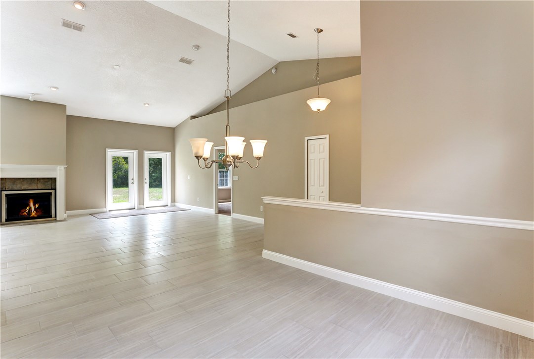 96921 Blackrock Road Yulee, FL 32097 - Photo 13 of 34 an empty room with wooden floor and windows
