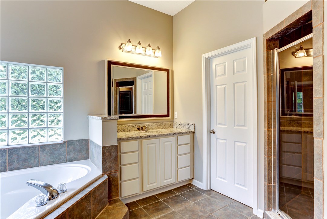 96921 Blackrock Road Yulee, FL 32097 - Photo 19 of 34 a bathroom with a tub sink and mirror