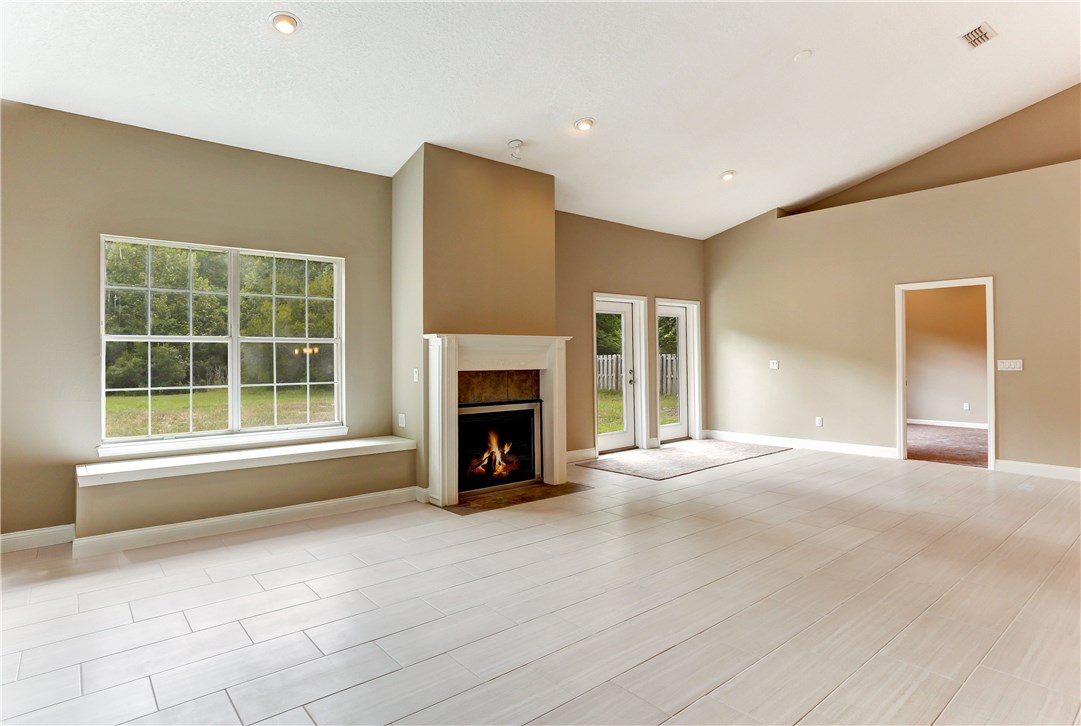 96921 Blackrock Road Yulee, FL 32097 - Photo 2 of 34 a view of an empty room with a window and a fireplace