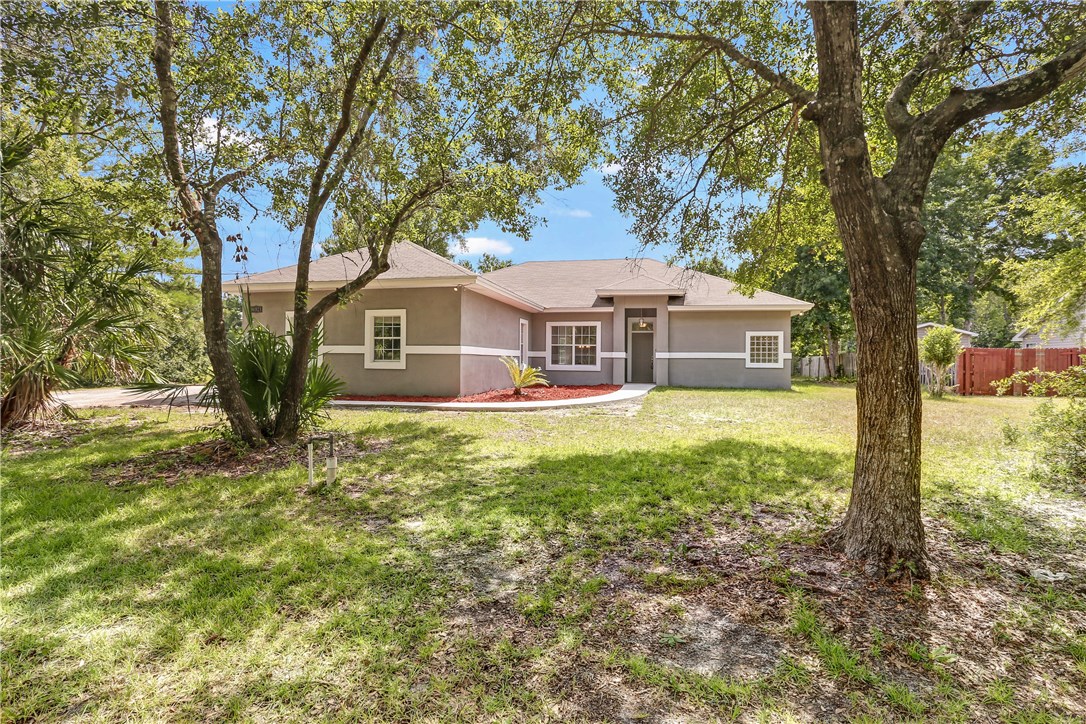 96921 Blackrock Road Yulee, FL 32097 - Photo 30 of 34 a front view of a house with garden