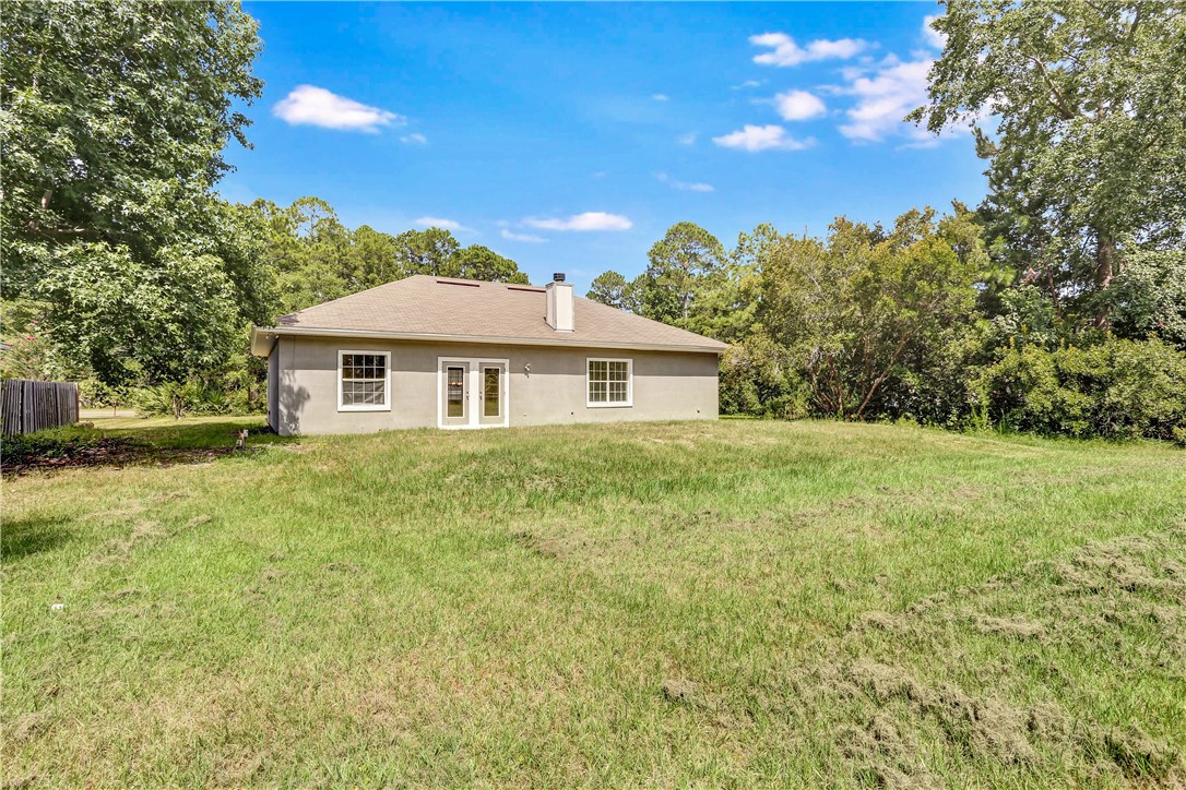 96921 Blackrock Road Yulee, FL 32097 - Photo 31 of 34 a front view of a house with a garden