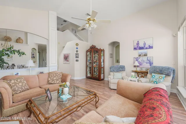 a spacious bedroom with a bed window and a dresser