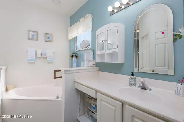 a bathroom with a double vanity sink and a mirror