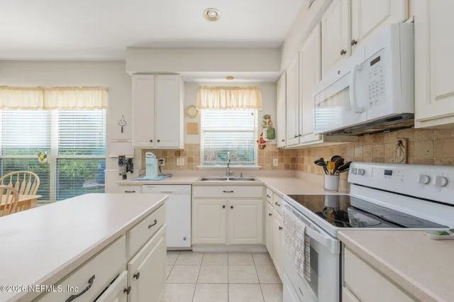 a view of a dining room that has a table and chairs