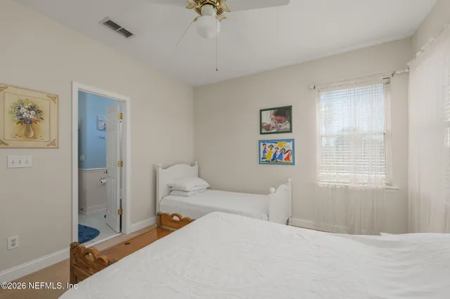 a bedroom with a bed a couch and a window