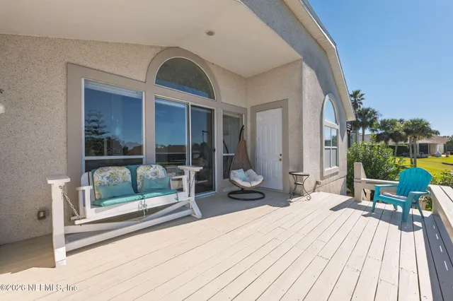 a view of balcony with wooden floor and seating space
