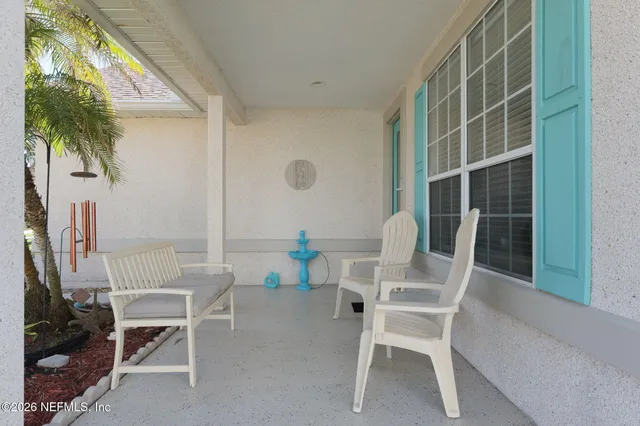 a dining room with furniture and a potted plant
