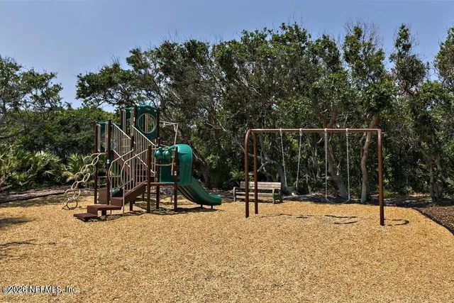 a front view of a house with a tree