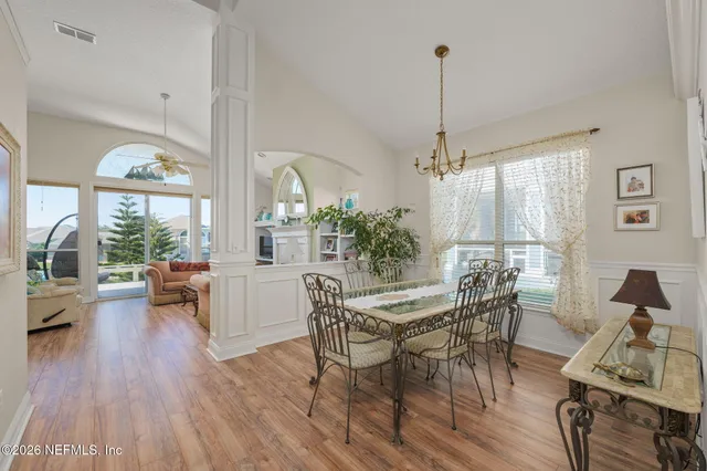 a living room with furniture a fireplace and a floor to ceiling window