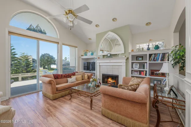 a living room with furniture a flat screen tv and a fireplace