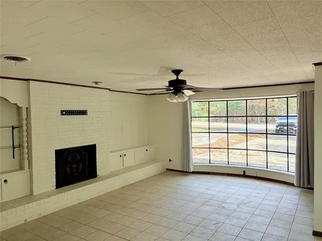 a view of a livingroom with a dishwasher and a large window
