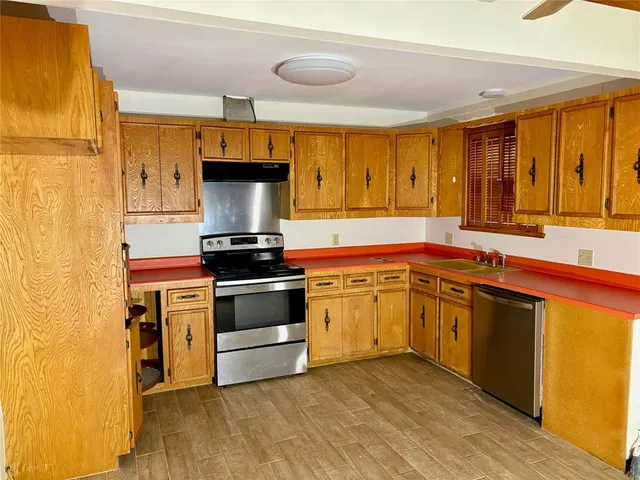 a kitchen with stainless steel appliances granite countertop a stove and a sink