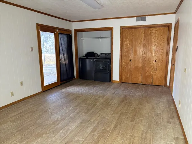 a view of empty room with a closet