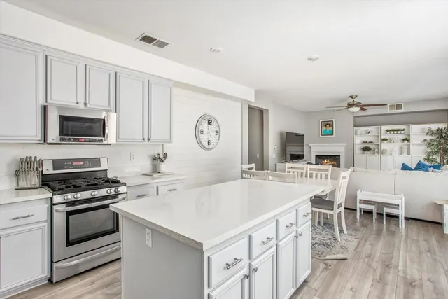 a large white kitchen with stainless steel appliances