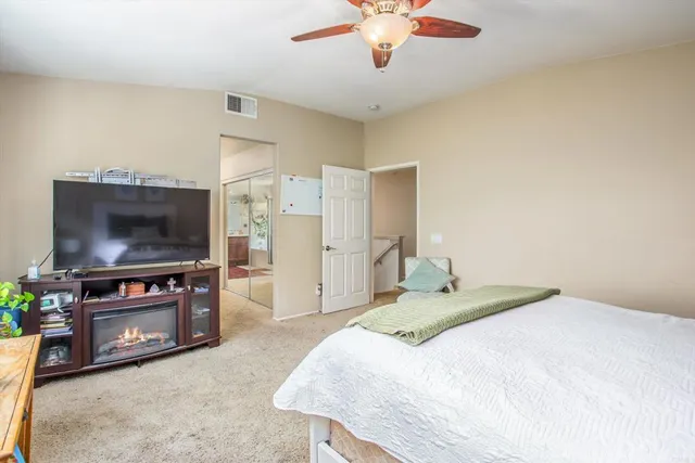 a bedroom with a bed and a flat screen tv