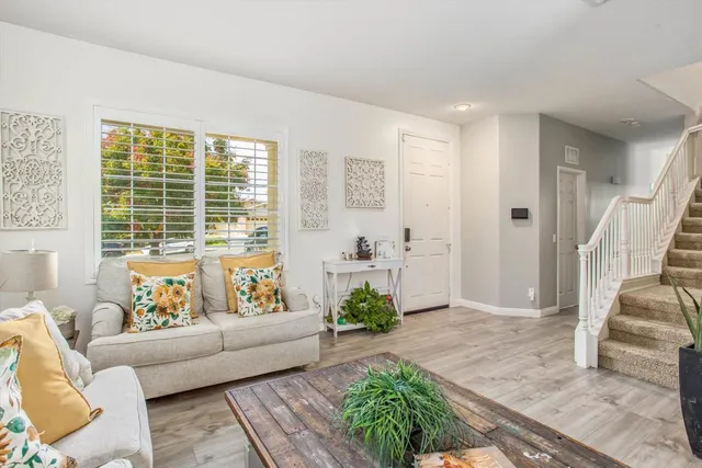 a living room with furniture and a large window