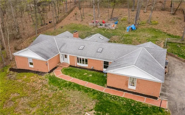 a aerial view of a house with a yard and garage