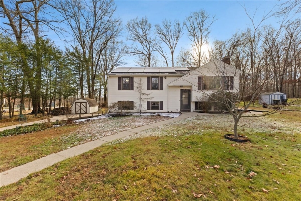 a view of a house with a yard covered in snow