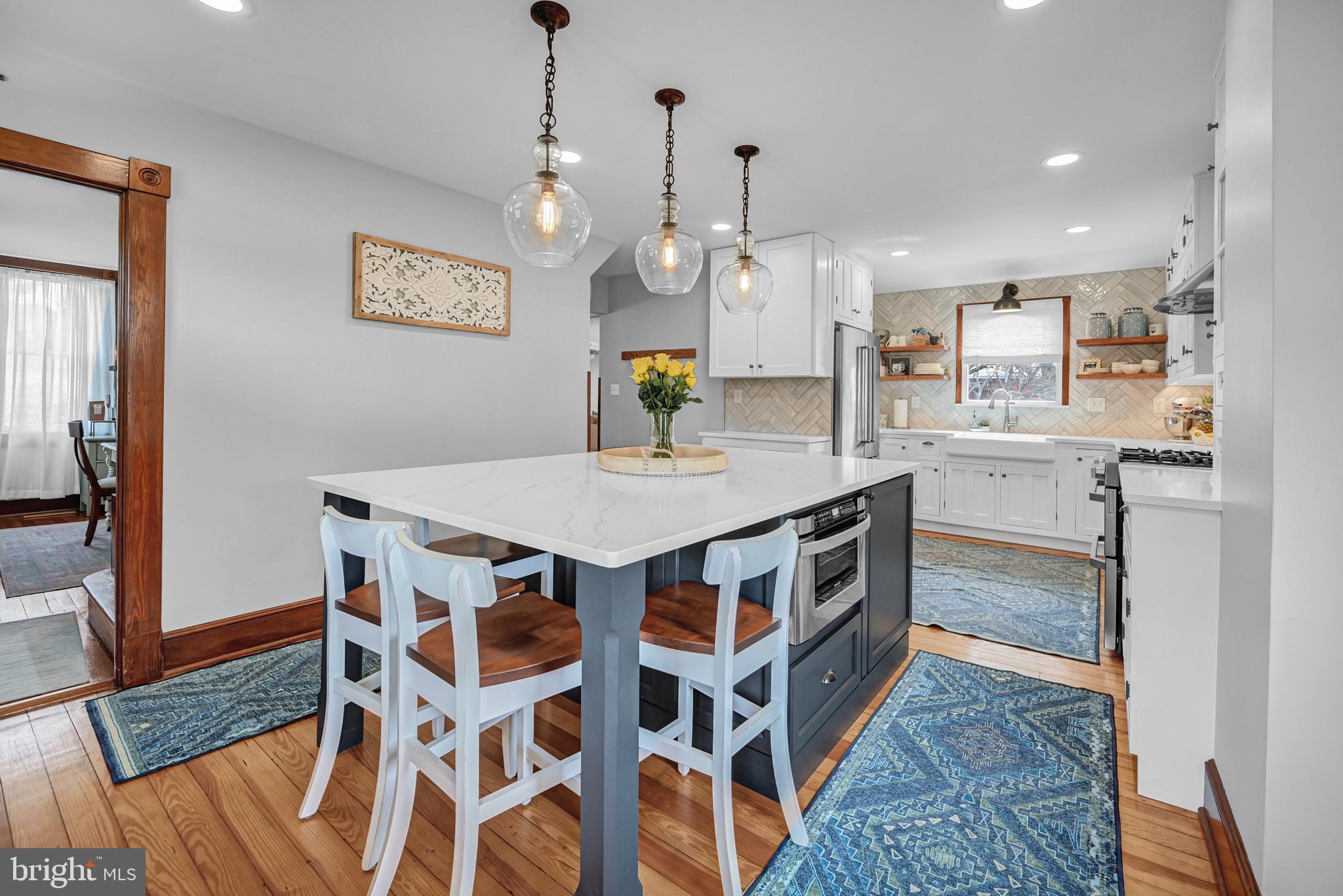 4207 Beckleysville Road Hampstead, MD 21074 - Photo 6 of 68 a kitchen with stainless steel appliances granite countertop a stove a sink a dining table and chairs