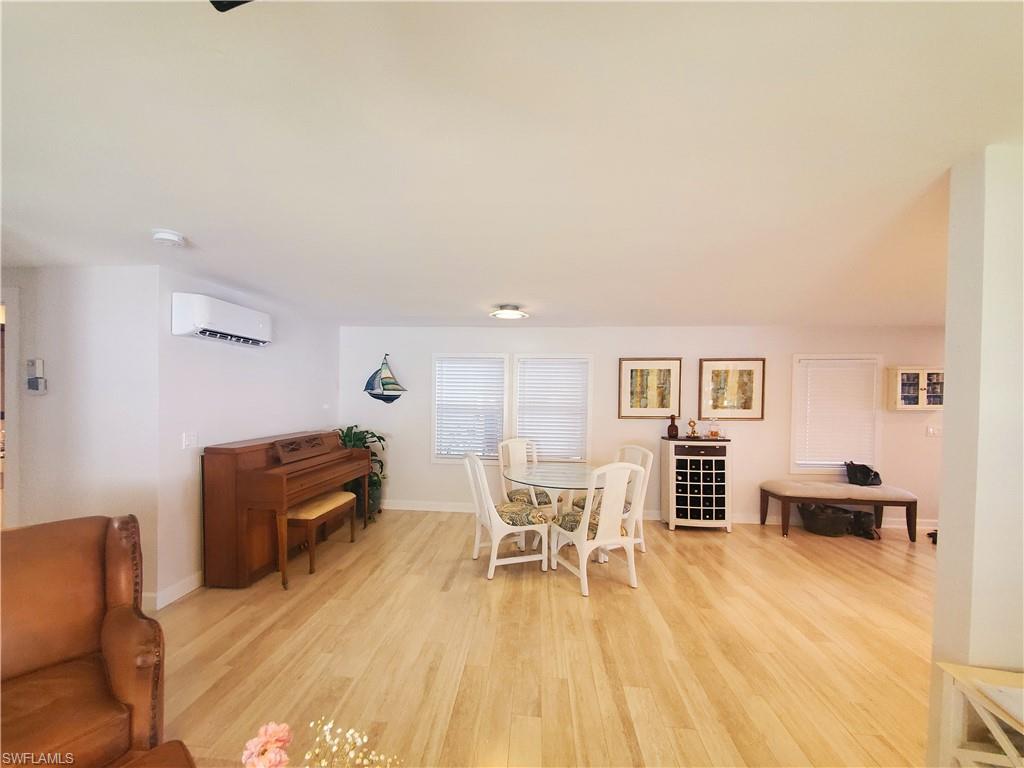7 Topaz Lane, Unit T7 Naples, FL 34112 - Photo 11 of 23 a living room with furniture and a wooden floor