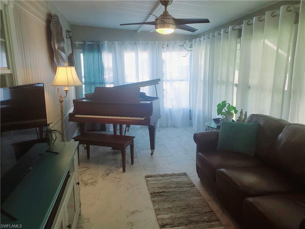 7 Topaz Lane, Unit T7 Naples, FL 34112 - Photo 13 of 23 a living room with furniture and a table