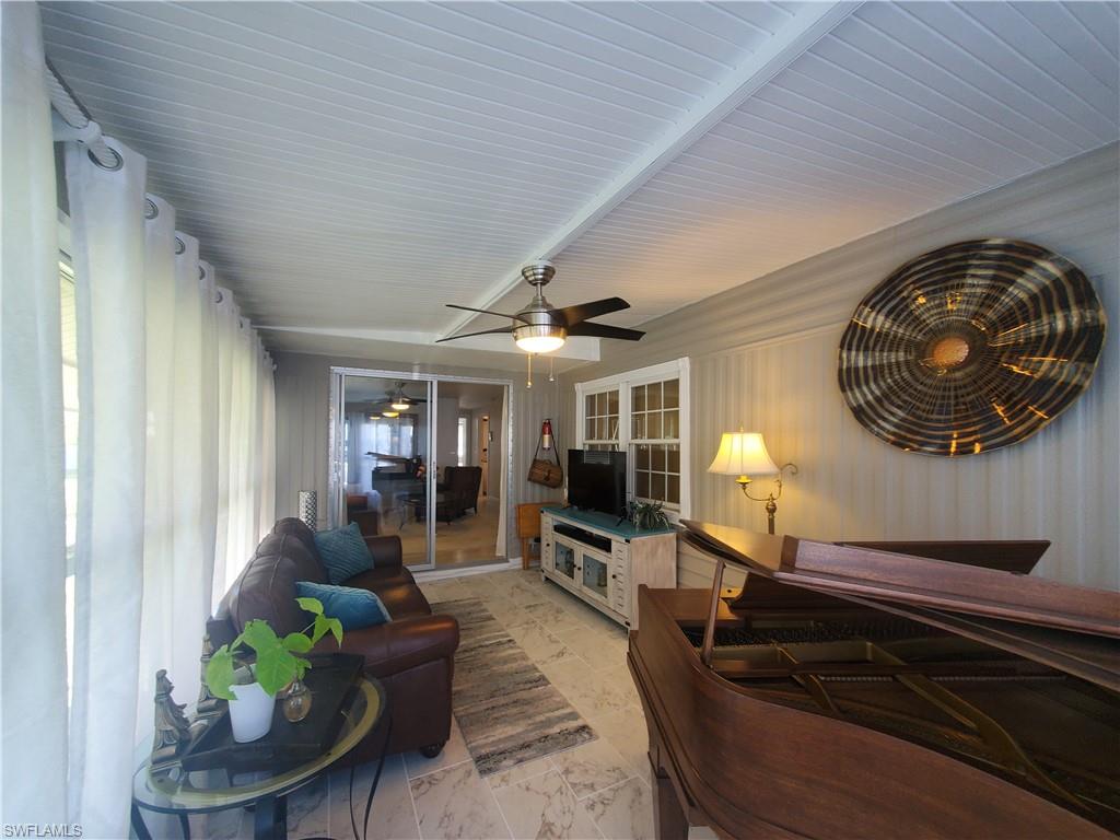 7 Topaz Lane, Unit T7 Naples, FL 34112 - Photo 14 of 23 a living room with furniture and a fireplace