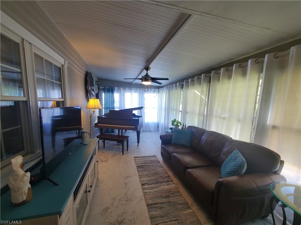 7 Topaz Lane, Unit T7 Naples, FL 34112 - Photo 15 of 23 a living room with furniture a dining table and a piano