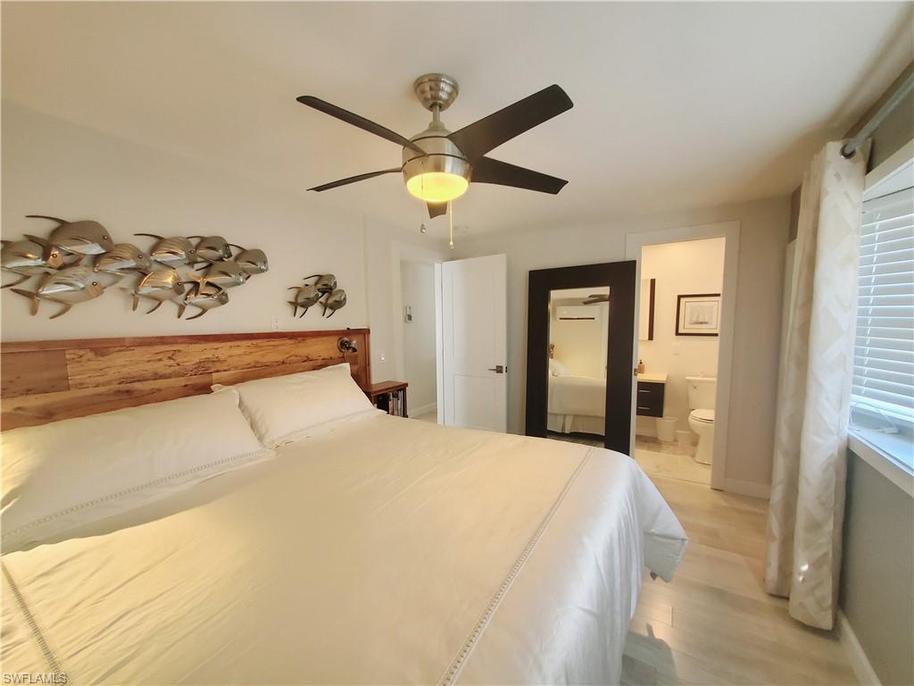 7 Topaz Lane, Unit T7 Naples, FL 34112 - Photo 16 of 23 a bedroom with a bed and a window