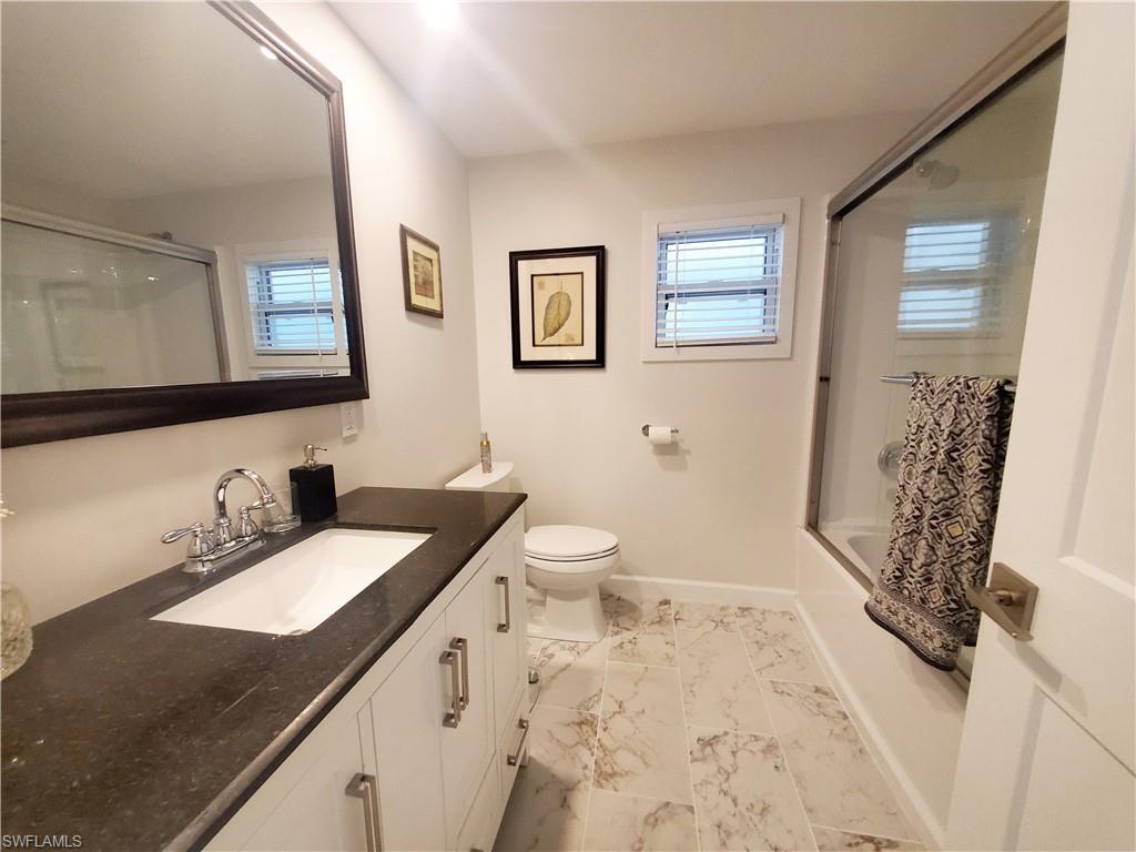 7 Topaz Lane, Unit T7 Naples, FL 34112 - Photo 22 of 23 a bathroom with a sink a toilet and shower