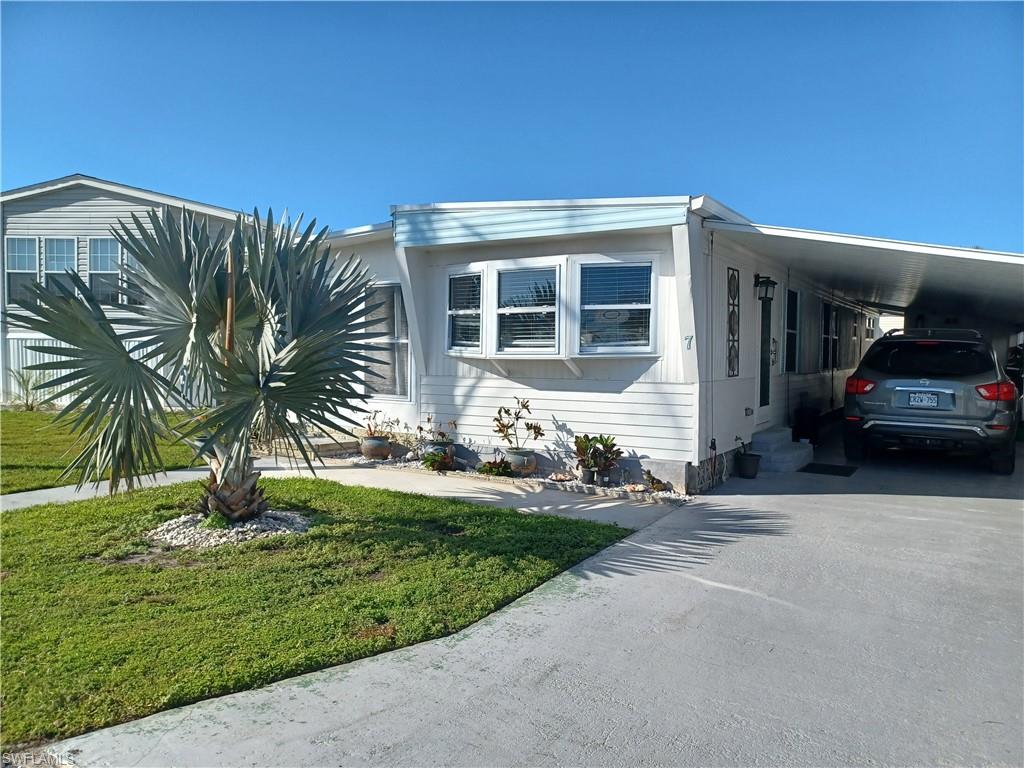 7 Topaz Lane, Unit T7 Naples, FL 34112 - Photo 23 of 23 a view of a house with a yard