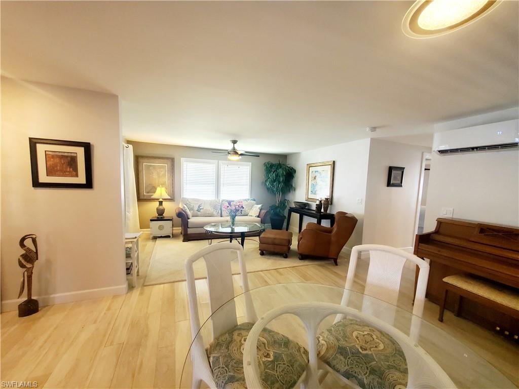 7 Topaz Lane, Unit T7 Naples, FL 34112 - Photo 8 of 23 a living room with furniture a couch and wooden floor