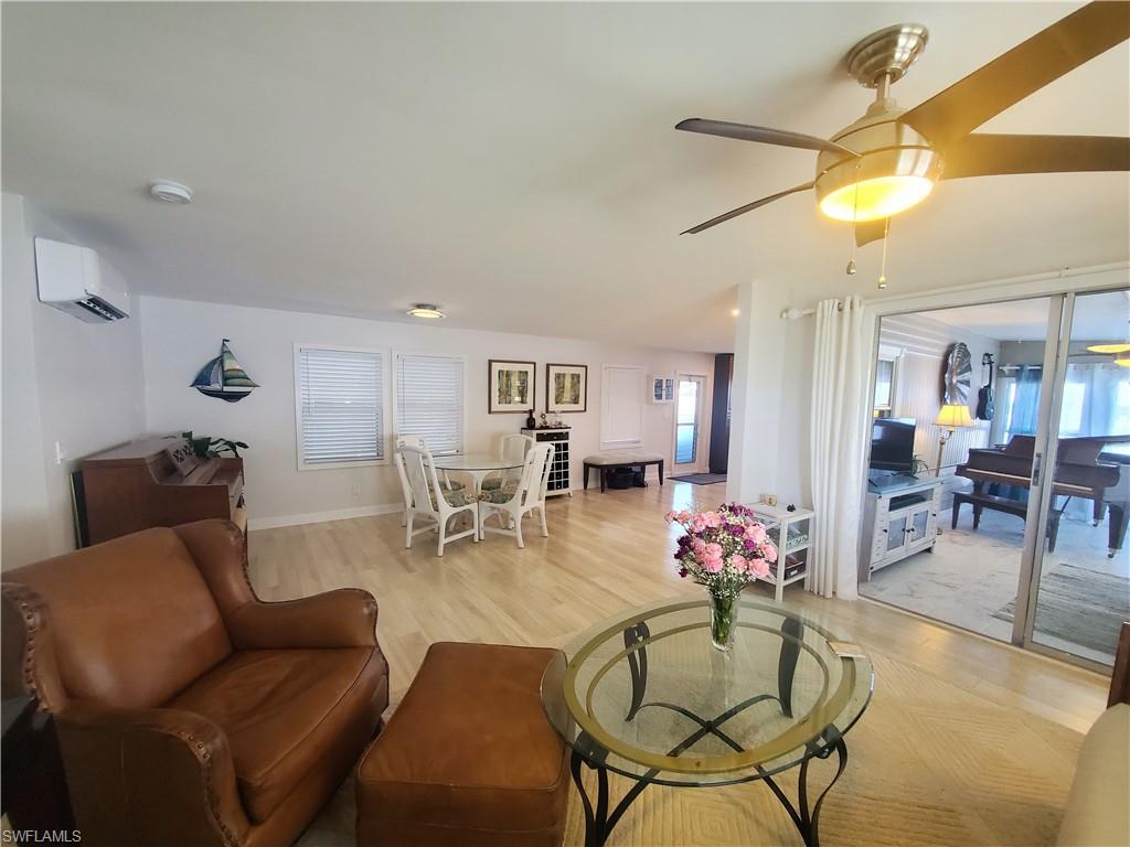 7 Topaz Lane, Unit T7 Naples, FL 34112 - Photo 10 of 23 a living room with furniture and wooden floor
