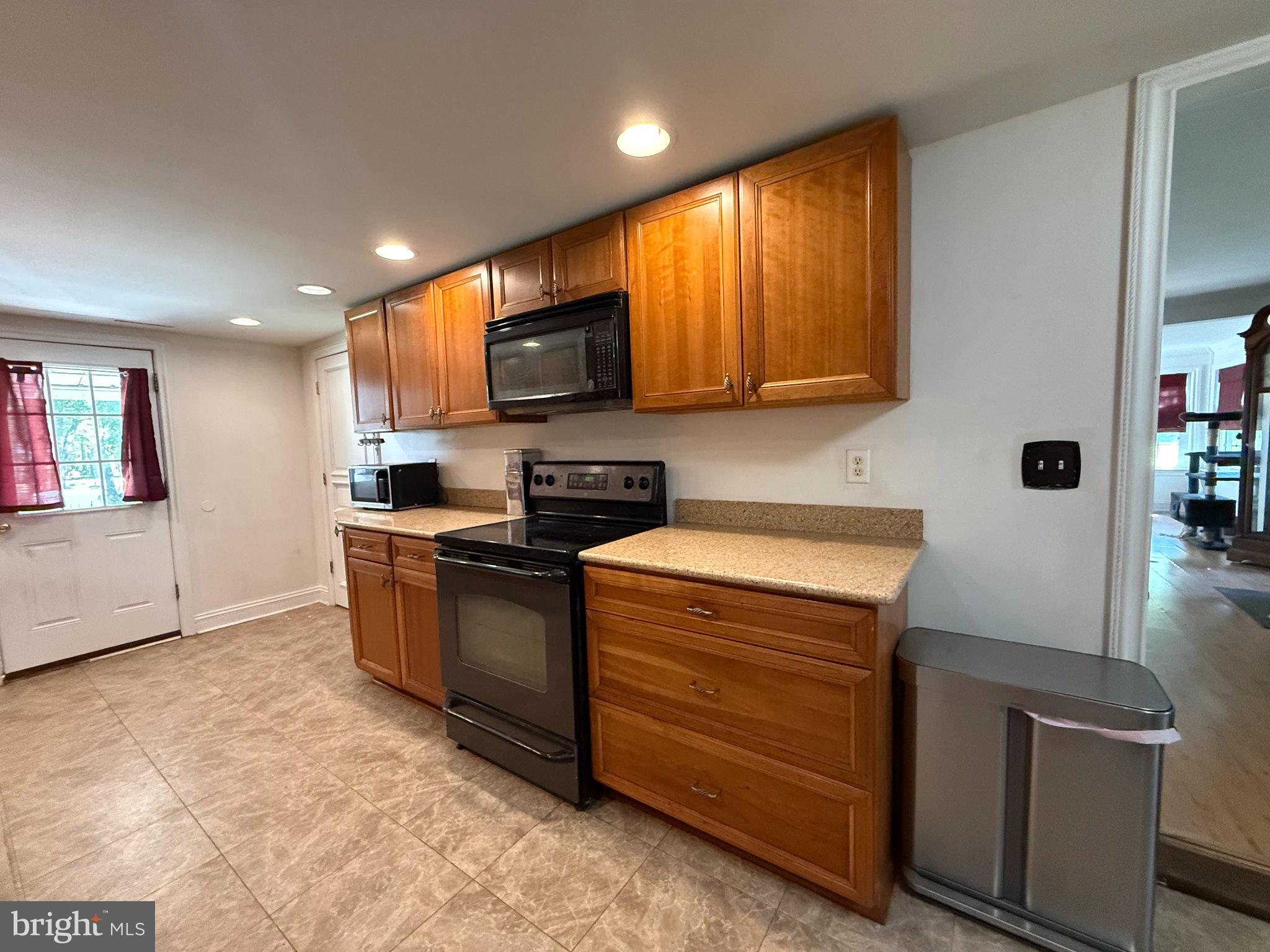 4818 Piney Neck Road Rock Hall, MD 21661 - Photo 5 of 24 a kitchen with stainless steel appliances granite countertop a stove a sink and a microwave