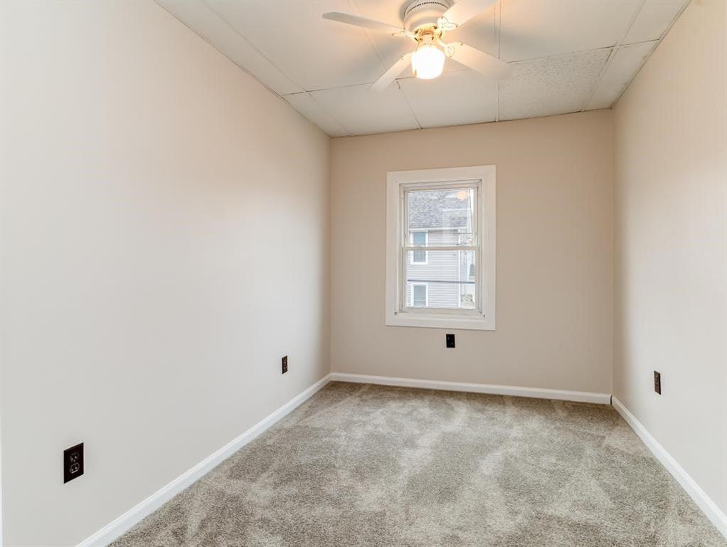 448 Park Street Rochester, PA 15074 - Photo 21 of 29 an empty room with a window and a fan