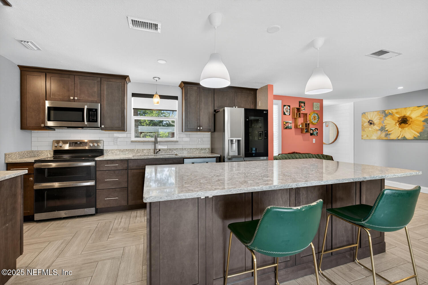 214 Deltona Boulevard St. Augustine, FL 32086 - Photo 15 of 23 a kitchen with stainless steel appliances granite countertop a stove top oven a sink a dining table and chairs
