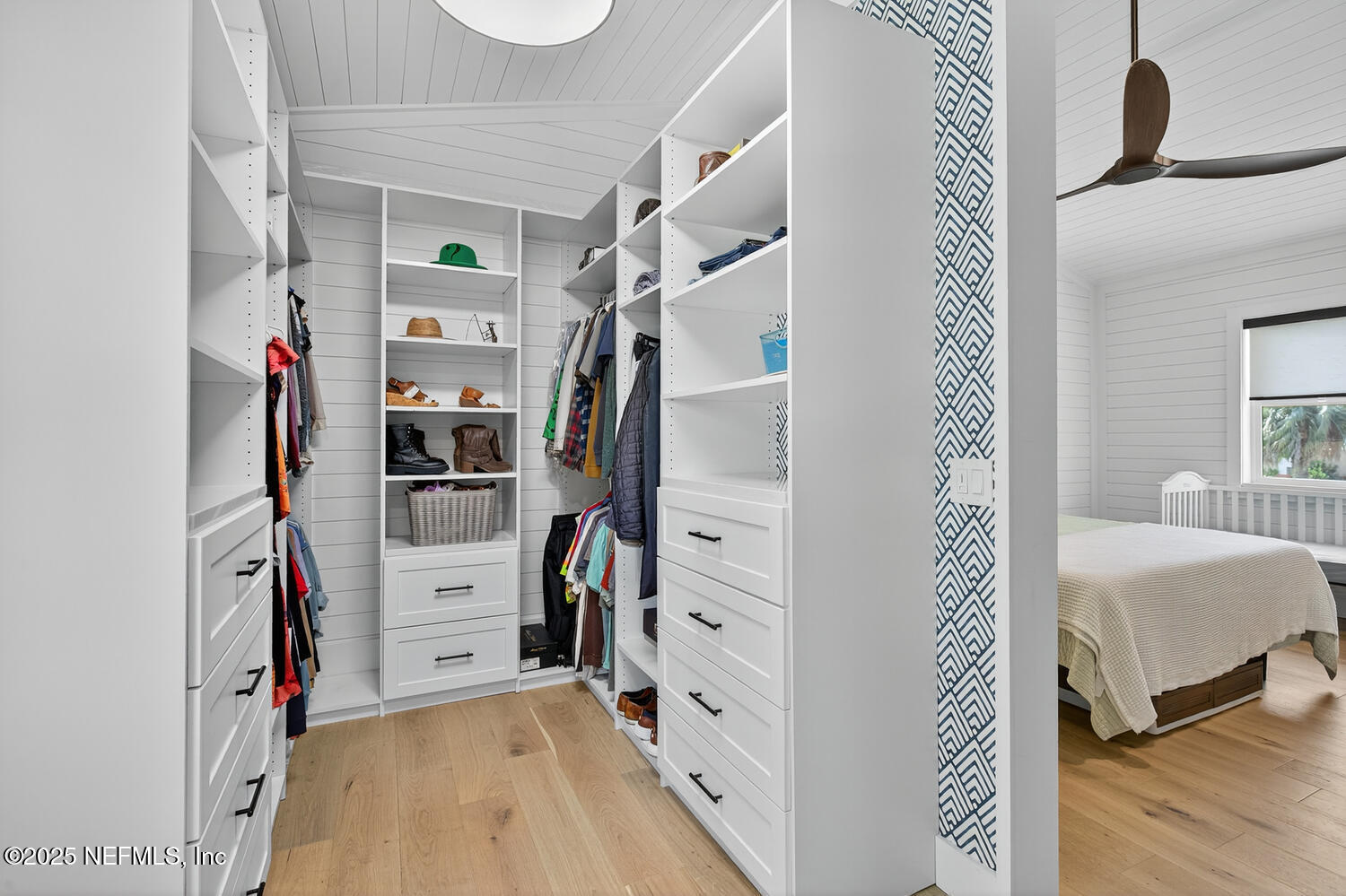 214 Deltona Boulevard St. Augustine, FL 32086 - Photo 19 of 23 a view of walk in closet with clothes and shoes