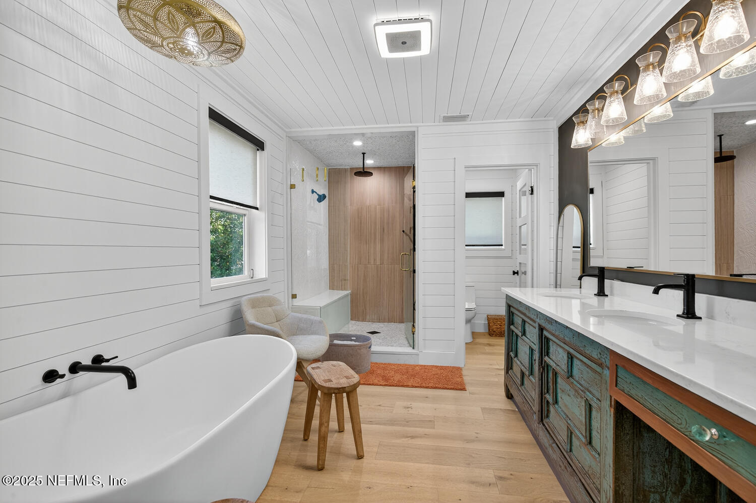 214 Deltona Boulevard St. Augustine, FL 32086 - Photo 20 of 23 a bathroom with a tub sink and mirror