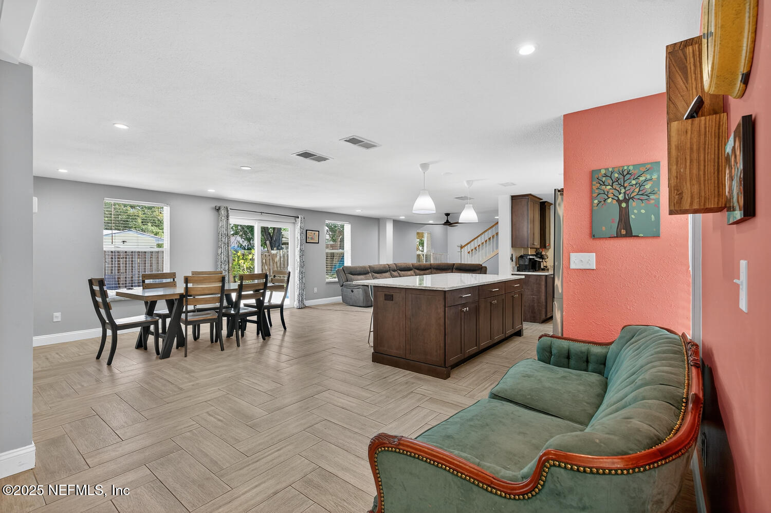 214 Deltona Boulevard St. Augustine, FL 32086 - Photo 10 of 23 a living room with furniture and a dining table