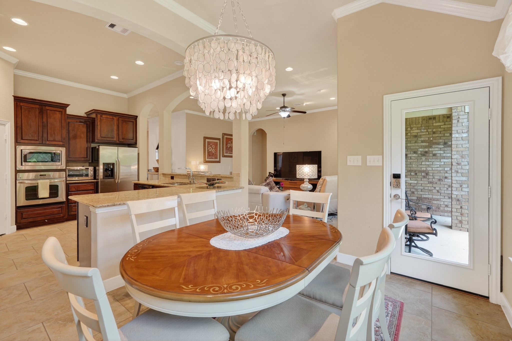 55 South Victoriana Circle Spring, TX 77389 - Photo 21 of 40 a dining room with wooden floor a chandelier a wooden table and chairs