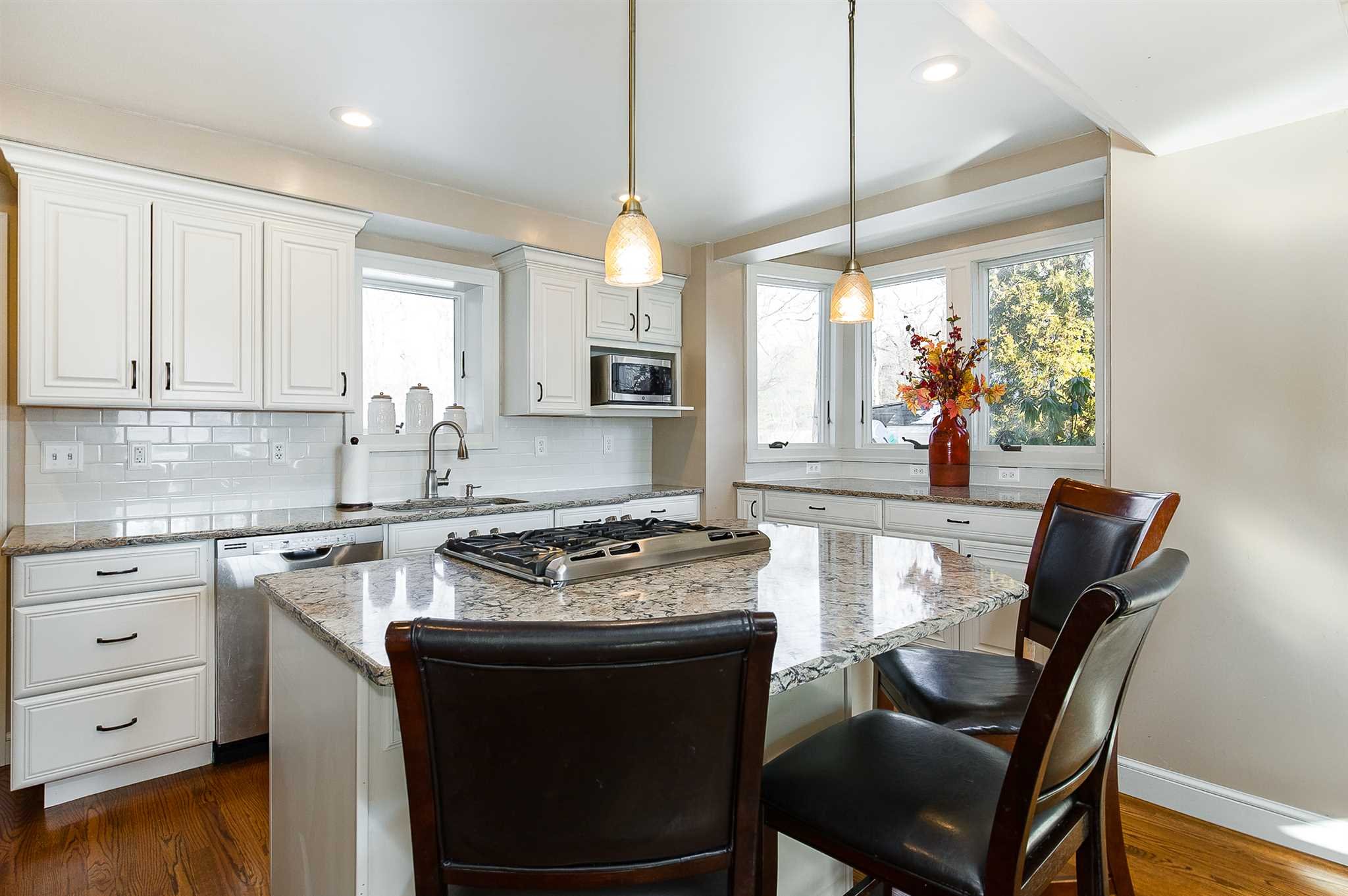 15 Meier Road LaGrange, NY 12603 - Photo 4 of 26 a kitchen with a stove a sink a dining table and chairs