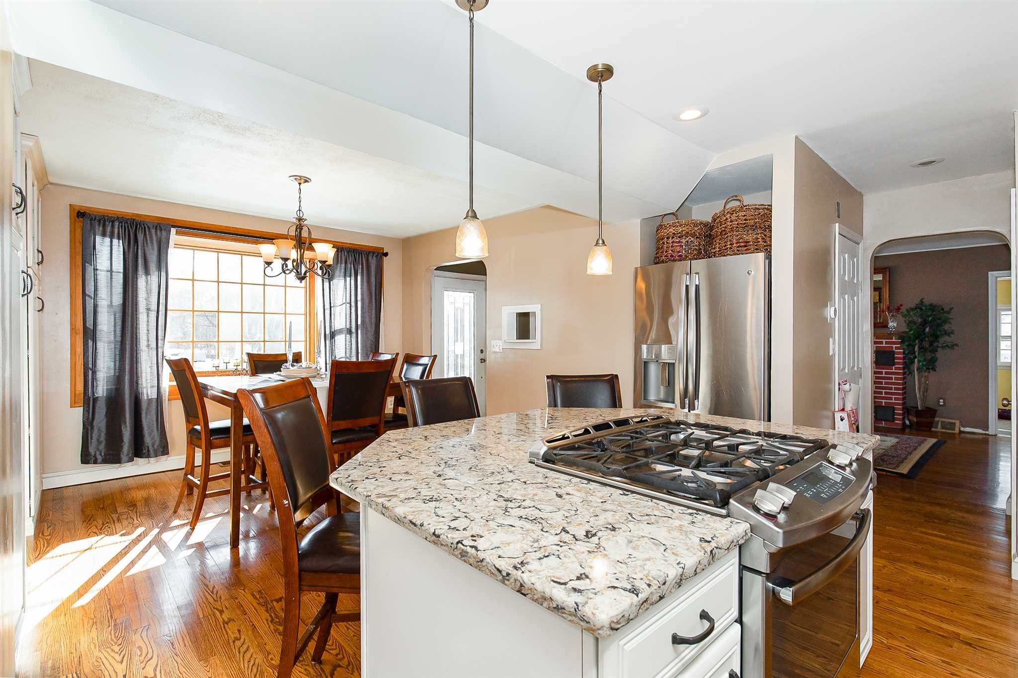 15 Meier Road LaGrange, NY 12603 - Photo 5 of 26 a kitchen island with stainless steel appliances kitchen island granite countertop a table chairs and a refrigerator
