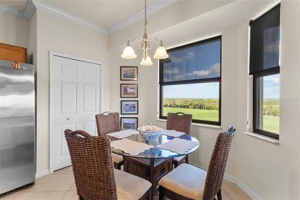 a kitchen with stainless steel appliances granite countertop a sink a stove and a dining table with wooden floor