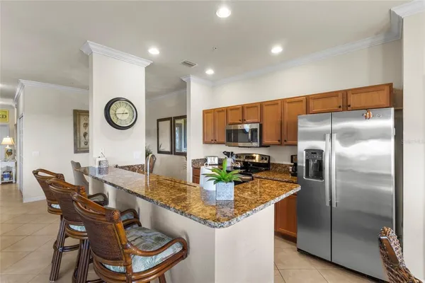 a kitchen with granite countertop a sink and a stove top oven