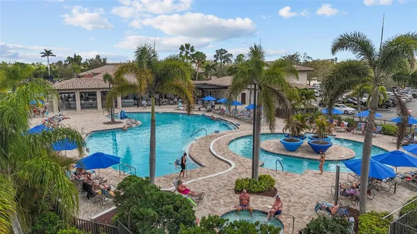 a view of a swimming pool with outdoor seating
