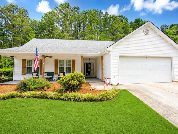 a front view of house with yard and green space
