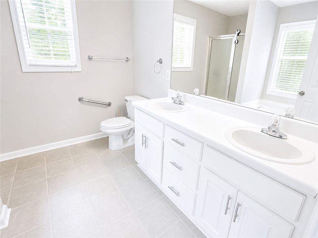 205 Richmond Hill Road Monroe, GA 30655 - Photo 11 of 15 a bathroom with a sink a toilet and a mirror