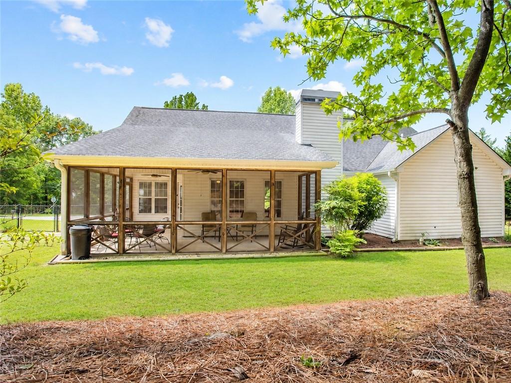 205 Richmond Hill Road Monroe, GA 30655 - Photo 14 of 15 a view of house with garden and tall trees